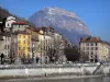 Grenoble - Facades of houses in the town, River Isère, trees and Mount Saint-Eynard (Chartreuse mountains)