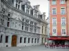 Grenoble - Facade of the former Palace of the Dauphiné Parliament (former courthouse) of Renaissance style, colorful facade of a house and café terrace on the Place Saint-André square