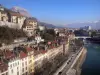Grenoble - Facades of houses and buildings of the town, quays, River Isère and mountains in the background