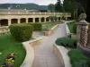 Gréoux-les-Bains - Spa town: Troglodyte thermal baths (spa establishment) and path lined with flowers and shrubs