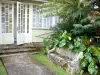 Hell-Bourg - Entrance to a Creole house with a stone bench and anthurium flowers