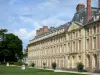 Jardines del castillo de Fontainebleau - Fachada del ala Luis XV, arbustos en macetas, estatuas, árboles y césped