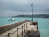 Landscapes of the Brittany coast - Cancale: pier decorated with a lamppost, boats on the sea, coast and turbulent sky