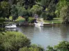 Landscapes of Val-d'Oise - Seine valley: Seine river, moored ferries, and trees along the water; in Herblay