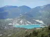 Lanscapes of Alpes-de-Haute-Provence - Emerald-coloured Castillon lake (water reservoir) surrounded by  mountains; in the Verdon Regional Nature Park