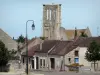 Larchant church - Tower of the Saint-Mathurin church, lamppost and houses in the village