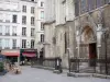 Latin district - Portal of the Saint-Séverin church, restaurant terrace and facades of the Saint-Séverin district