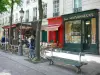 Latin district - Café terrace and bookstore of the Place de la Sorbonne square with bench in the foreground