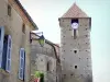 Madiran - Church bell tower and facade of a house in the village