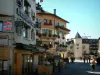 Megève - Pedestrian street of the village (winter and summer sports resort) with shops, café terrace and houses with flower-bedecked windows and balconies