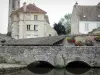 Milly-la-Forêt - Stone bridge spanning the river, wash house of La Bonde, bell tower of the Notre-Dame-de-l'Assomption church and houses of the village