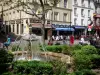 Mouffetard street - Fountain on the Contrescarpe square and facades of the Rue Mouffetard street