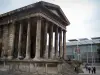 Nîmes - Square house (Maison Carrée, ancientRoman temple) in foreground, Carré d'Art (modern building home to the Contemporary Art museum)