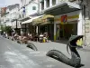 Niort - Bronze dragon, café terrace and shops of the Rue Ricard street