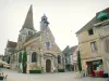 Nolay - Saint-Martin church with its stone bell tower and houses of the medieval town