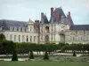 Palace of Fontainebleau - Palace of Fontainebleau (Golden Gate) and large flowerbed of the French-style formal garden