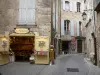 Pézenas - Old town: narrow paved street, workshops, stone houses