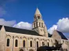 Poitiers - Notre-Dame-la-Grande church of Romanesque style and its bell tower, clouds in the blue sky