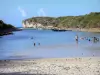 Porte d'Enfer lagoon - Sandy beach, lagoon with swimmers and Porte d'Enfer cliffs; on the island of Grande-Terre
