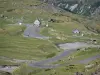 Pyrenees landscapes - Winding mountain road bordered with pasture (grass) leading to the Troumouse cirque