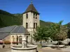 Quézac - Bell tower of the Notre-Dame church (former collegiate church) and fountain; in the Cévennes National Park