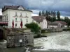 Quingey - Loue river, dam and houses of the village with a heavy sky