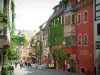 Riquewihr - High street (Général-de-Gaulle street): residence with an oriel window, colourful houses decorated with flowers and creepers, cafe terraces