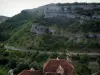 Rocamadour - Roofs of houses of the village with view of trees and surrounding rock faces, in the Regional Nature Park of the Quercy Limestone Plateaus