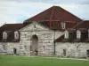 The royal saltworks of Arc-et-Senans - Royal saltworks of Arc-et-Senans: Building of the former royal saltworks and lawn dotted with flowers