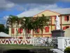 Saint-André - Statue of Virgin Mary and colorful facade of the town