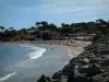 Saint-Aygulf - Cliffs, sandy beach with tourists, pine trees and houses of the seaside resort