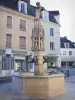 Saint-Florentin - Fountain with dragons and facades of houses in the city