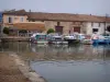 Saint-Gilles - Sailing and fishing harbour with its moored boats, restaurant terrace and houses of the town