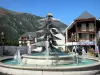 Saint-Lary-Soulan - Spa town and ski resort: fountain, houses of the village and mountains; in the Aure valley