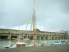 Saint-Nazaire - Port: boats, former submarine base (Escal' Atlantic Passenger Ships International Centre), and turbulent sky