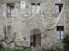 Saint-Suliac - Façade d'une maison en pierre ornée d'un filet de pêche