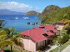 Les Saintes - Houses of Terre-de-Haut island overlooking the Caribbean sea and sailboats floating on water