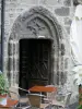 Salers - Gate of Gothic entrance of the house Blaud-Lacombe and terrace of coffee