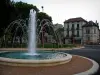 Salies-du-Salat - Pond with fountains, trees and houses of the spa town