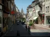 Sarrebourg - Shopping street with shops, houses and church bell tower in background
