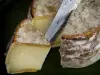 Savoie Tomme cheese - Piece of cheese and a knife blade