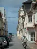 Touquet-Paris-Plage - Street with cyclists and houses, the Channel (sea) in background