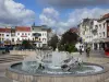 Tourcoing - Fountains of the Grand'Place square, shops and houses of the city, clouds in the blue sky