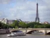 Urban landscape - Cruise ship sailing on the Seine river, Invalides bridge, and Eiffel tower dominating the set