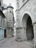 Ussel - Porch of the Church of St. Martin and corbelled turret of a house in the old town