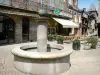 Uzerche - Fountain and café terrace of the Place Marie Colein