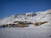 Val Thorens - Snowy slope (snow) with view of the chalets and buildings of the ski resort (winter sports) and the mountain