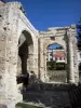 Vienne - Cybèle garden (Archaeological Garden): arches of the forum portico (Gallo-Roman remains); facade of the Vienne theater in the background