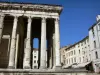 Vienne - Auguste and Livie temple (Roman temple) with Corinthian columns and facades of the Place du Palais square