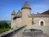 Virieu castle - Medieval fortress and fountain of the front courtyard in the foreground